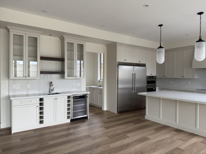 White kitchen with built-in wine storage in a Sherwood Park home