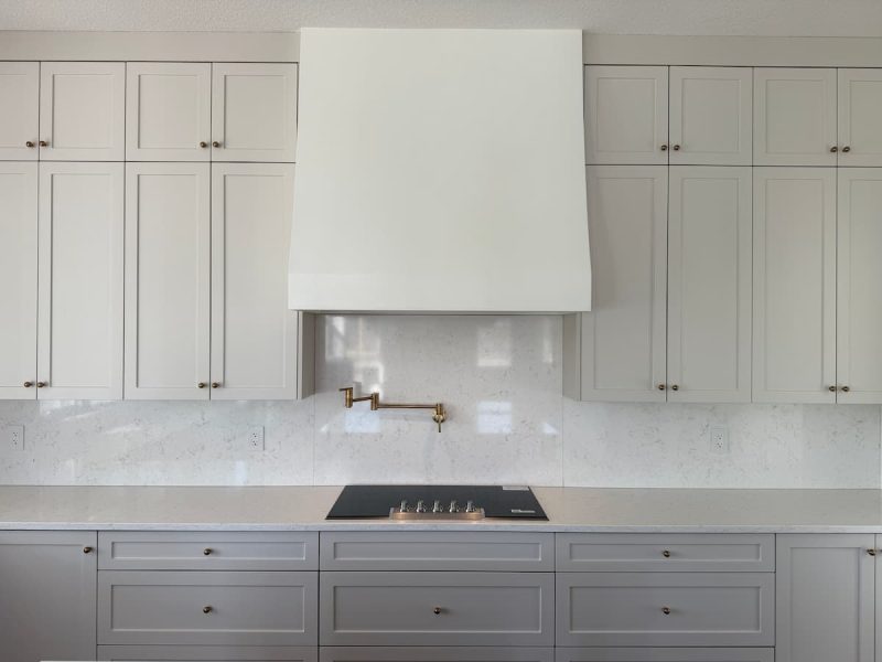 White shaker kitchen with a custom plaster hood fan in an Ardrossan home